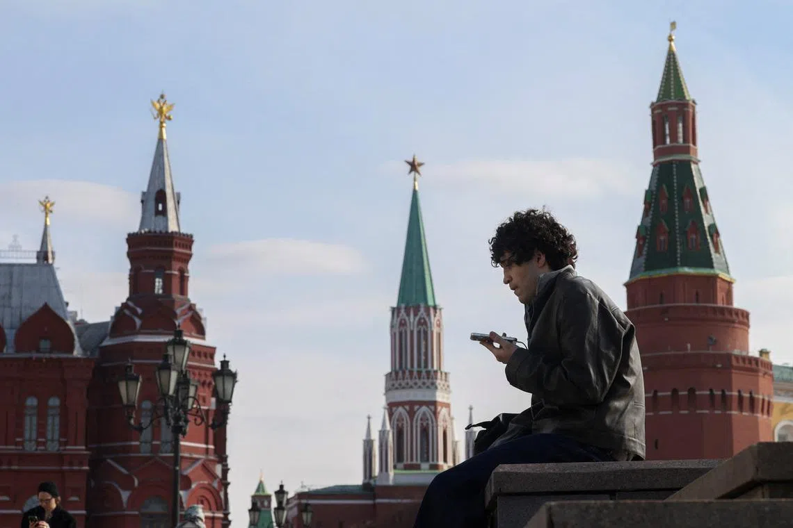 A man checks his mobile phone in central Moscow, Russia March 17, 2026.