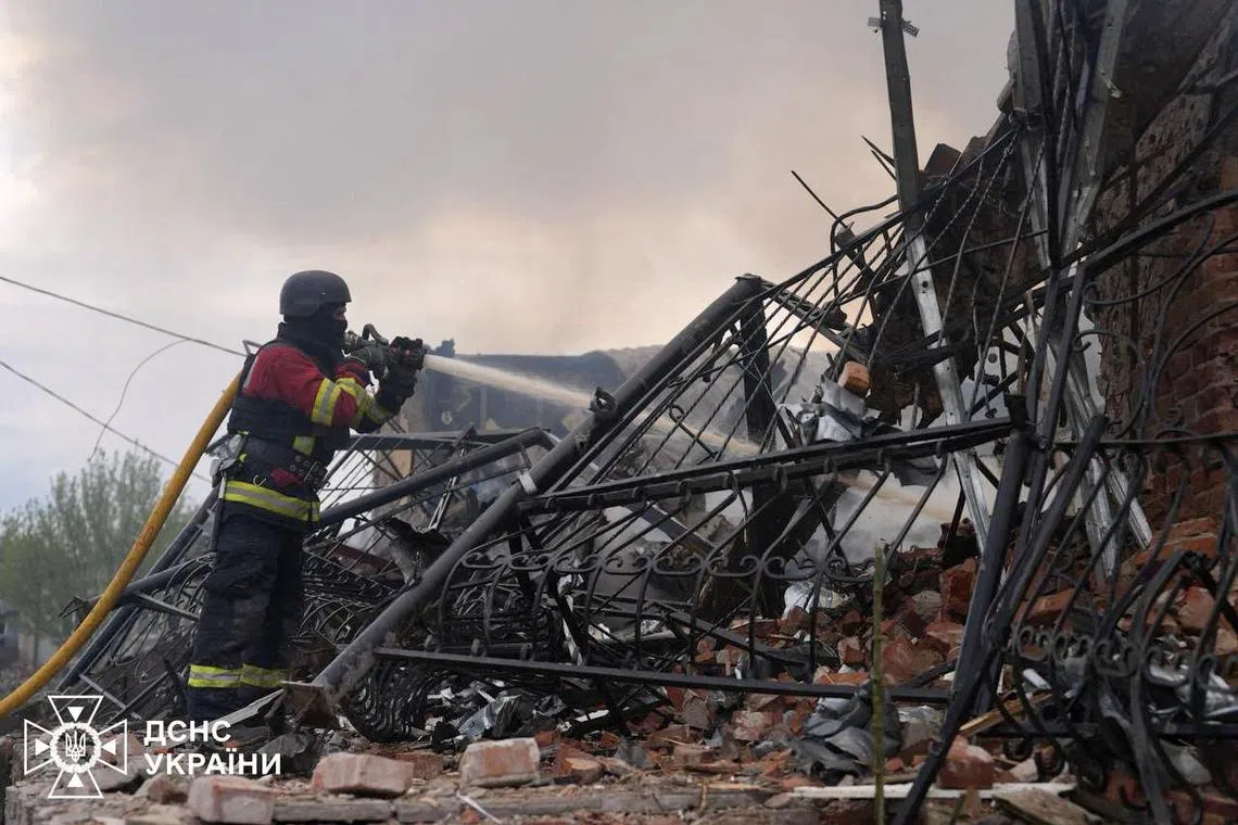 A firefighter putting out a blaze in Ukraine's Sumy region, following a Russian air strike on a building on May 6.