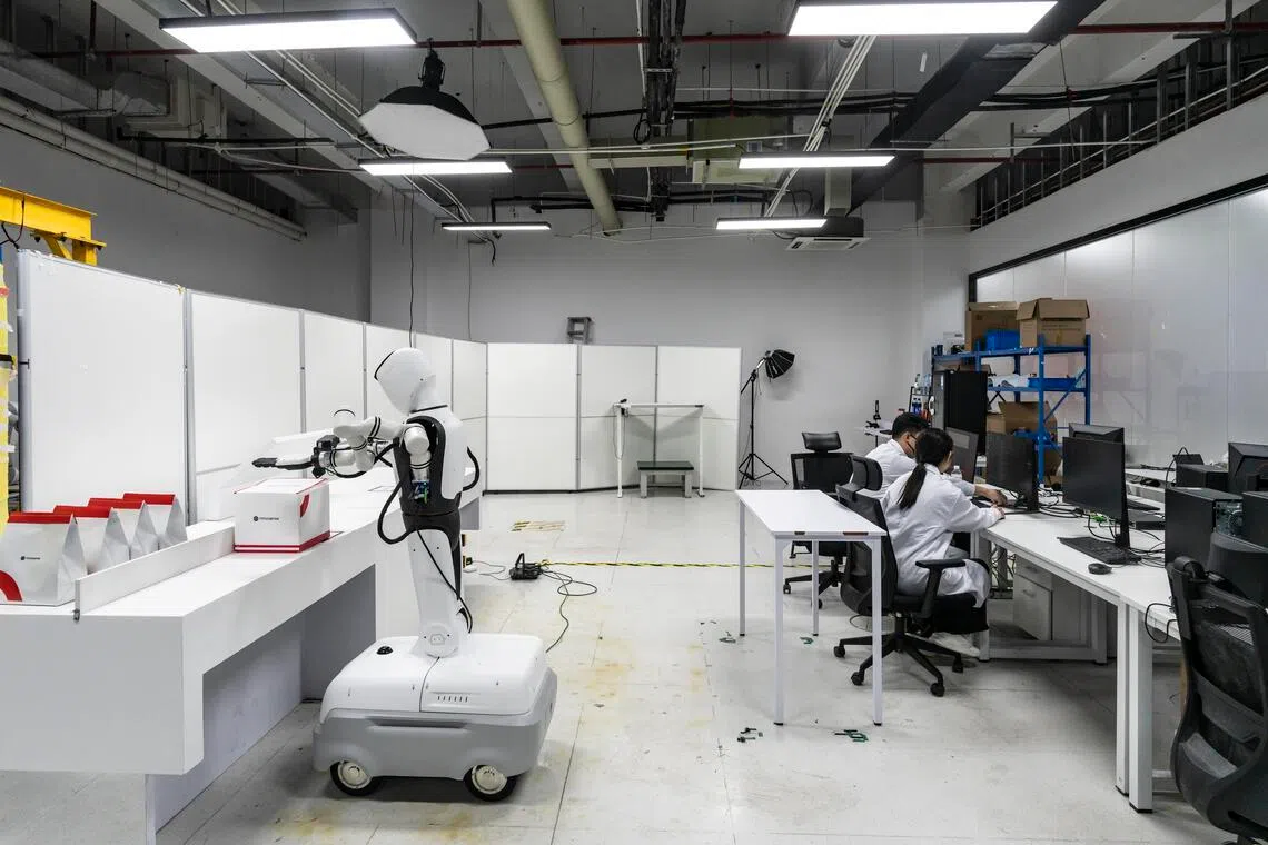 A robot learning to unpack and fold boxes at a lab working with Meituan in Shenzhen, China.