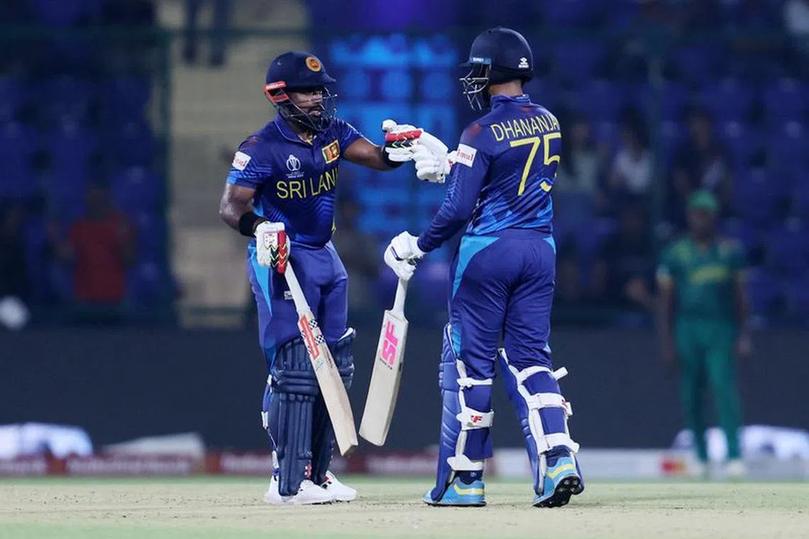 Cricket - ICC Cricket World Cup 2023 - South Africa v Sri Lanka - Arun Jaitley Stadium, New Delhi, India - October 7, 2023 Sri Lanka's Charith Asalanka and Dhananjaya de Silva bump fists during their innings REUTERS/Anushree Fadnavis/File Photo