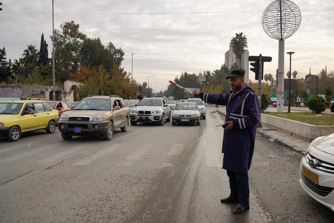 A traffic police directs cars, after rebels took the main northern city of Aleppo and have since pushed south from their enclave in northwest of the country, in Aleppo, Syria, December 4, 2024. REUTERS/Karam al-Masri