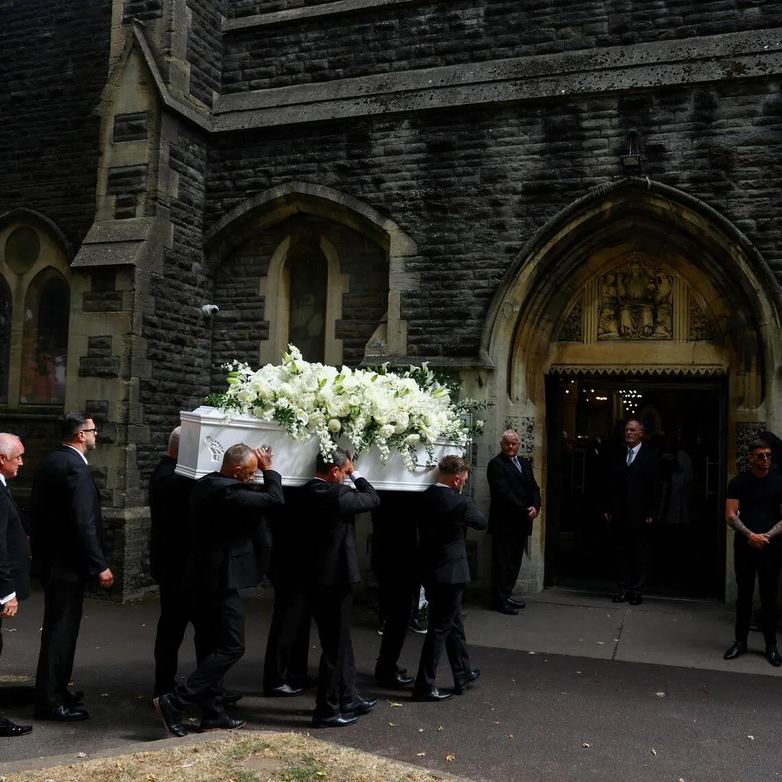 Pallbearers carry the coffin containing the remains of Gaynor Sullivan, known professionally as Bonnie Tyler, at Swansea Minster for the memorial service.