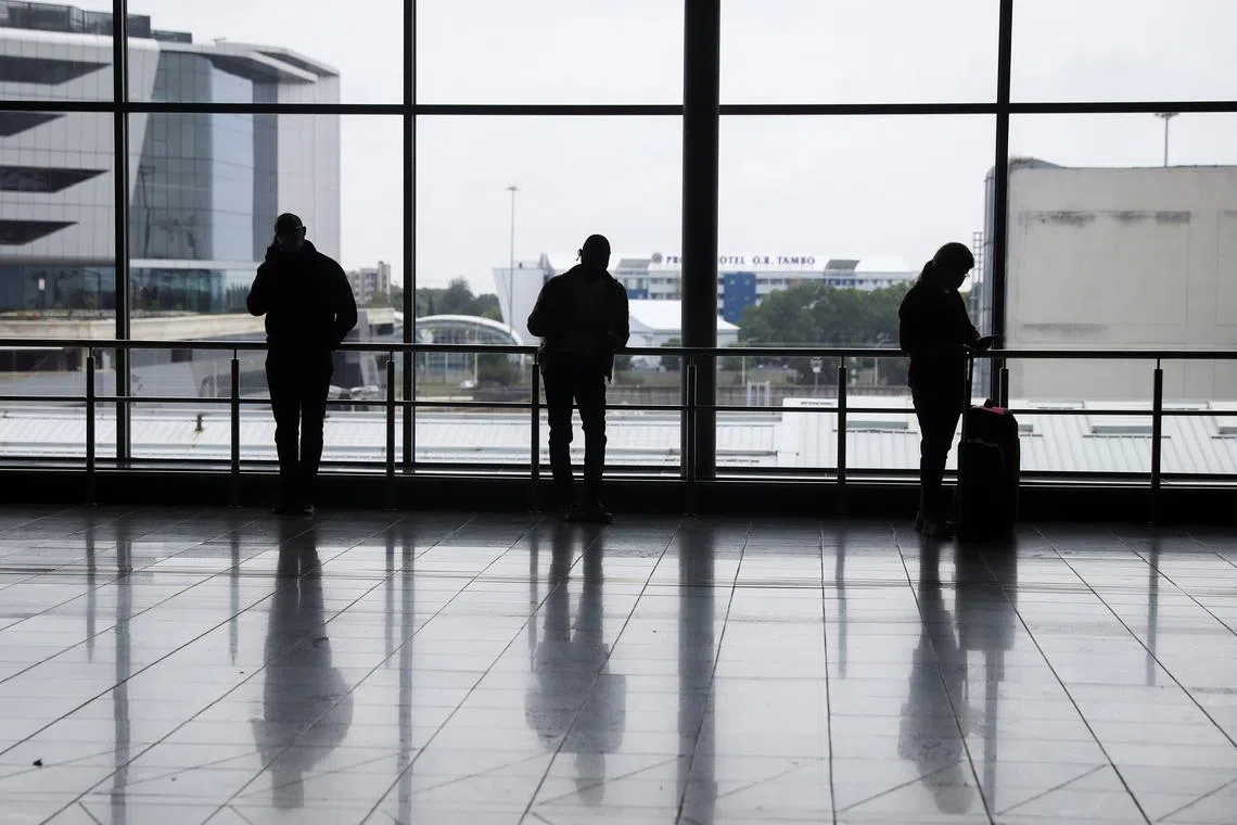 Passengers wait to board international flights at O.R. Tambo International Airport in Johannesburg, South Africa, November 28, 2021. REUTERS/ Sumaya Hisham/File Photo