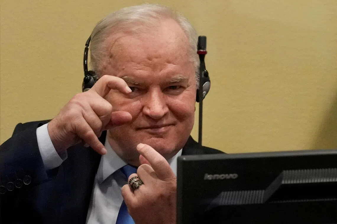 A 2021 photo shows former Bosnian Serb military leader Ratko Mladic gesturing at a hearing in The Hague, Netherlands.