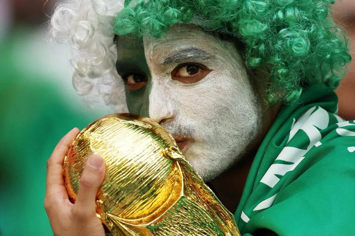 A Saudi Arabia fan with a replica World Cup trophy. The Saudis famously sprung one of the great World Cup upsets when they beat Argentina at the 2022 and are aiming to start strongly against Uruguay in this edition.