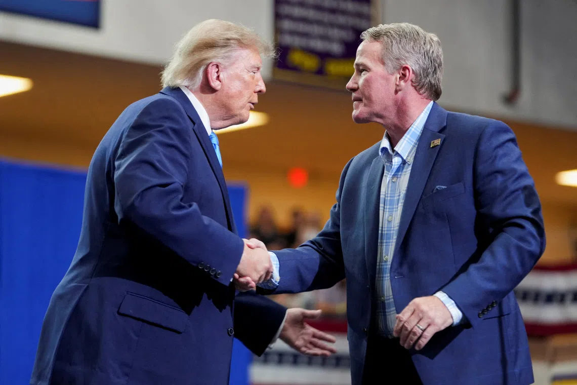FILE PHOTO: Senator Jon Husted (R-OH) shakes hands with US President Donald Trump at a rally at Butler High School in Vandalia, Ohio, US, October 3, 2026. REUTERS/Nathan Howard/File Photo