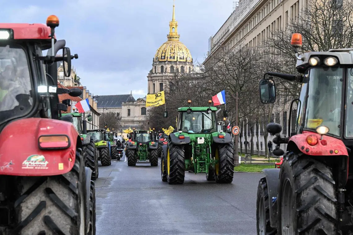 French farmers drive tractors through western Paris, ahead of the 60th International Agriculture Fair, which attracts around 600,000 visitors over nine days..