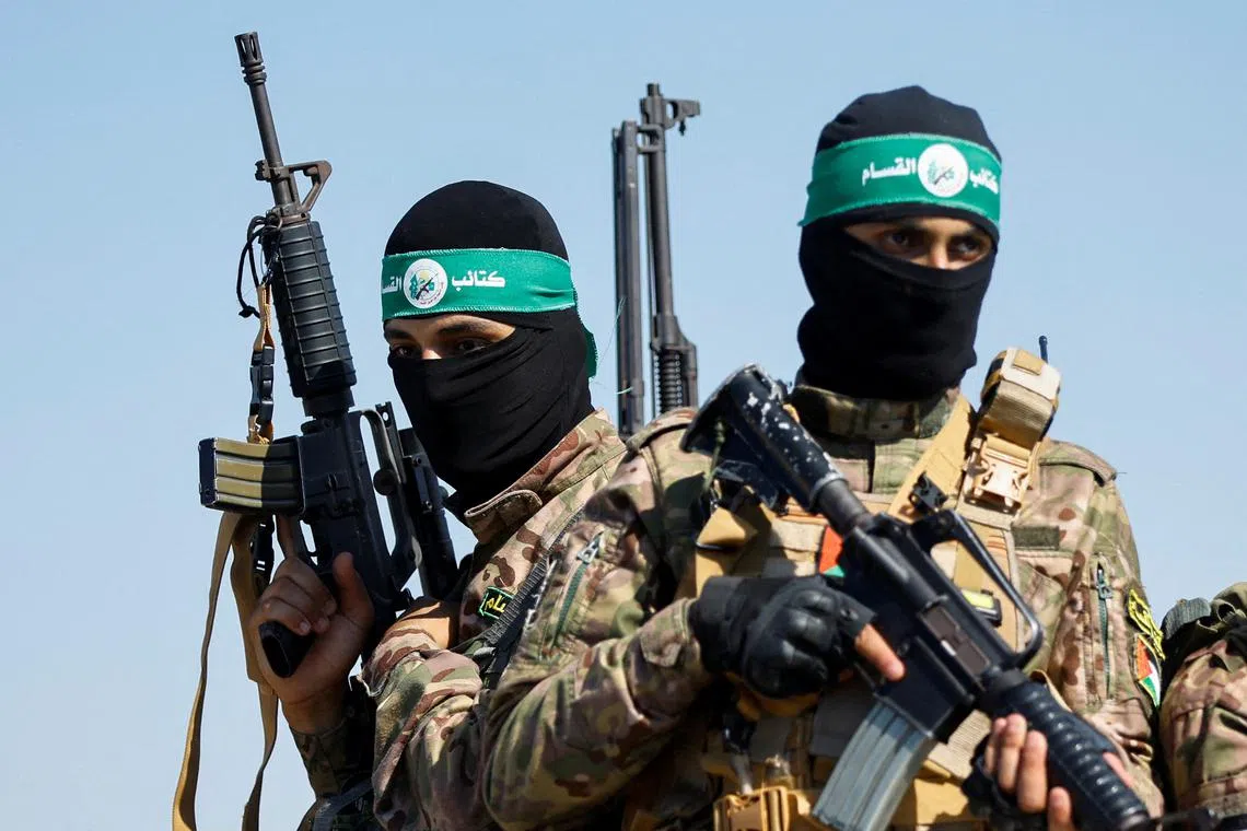 FILE PHOTO: Palestinian fighters from the armed wing of Hamas take part in a military parade to mark the anniversary of the 2014 war with Israel, near the border in the central Gaza Strip, July 19, 2023. REUTERS/Ibraheem Abu Mustafa/File Photo