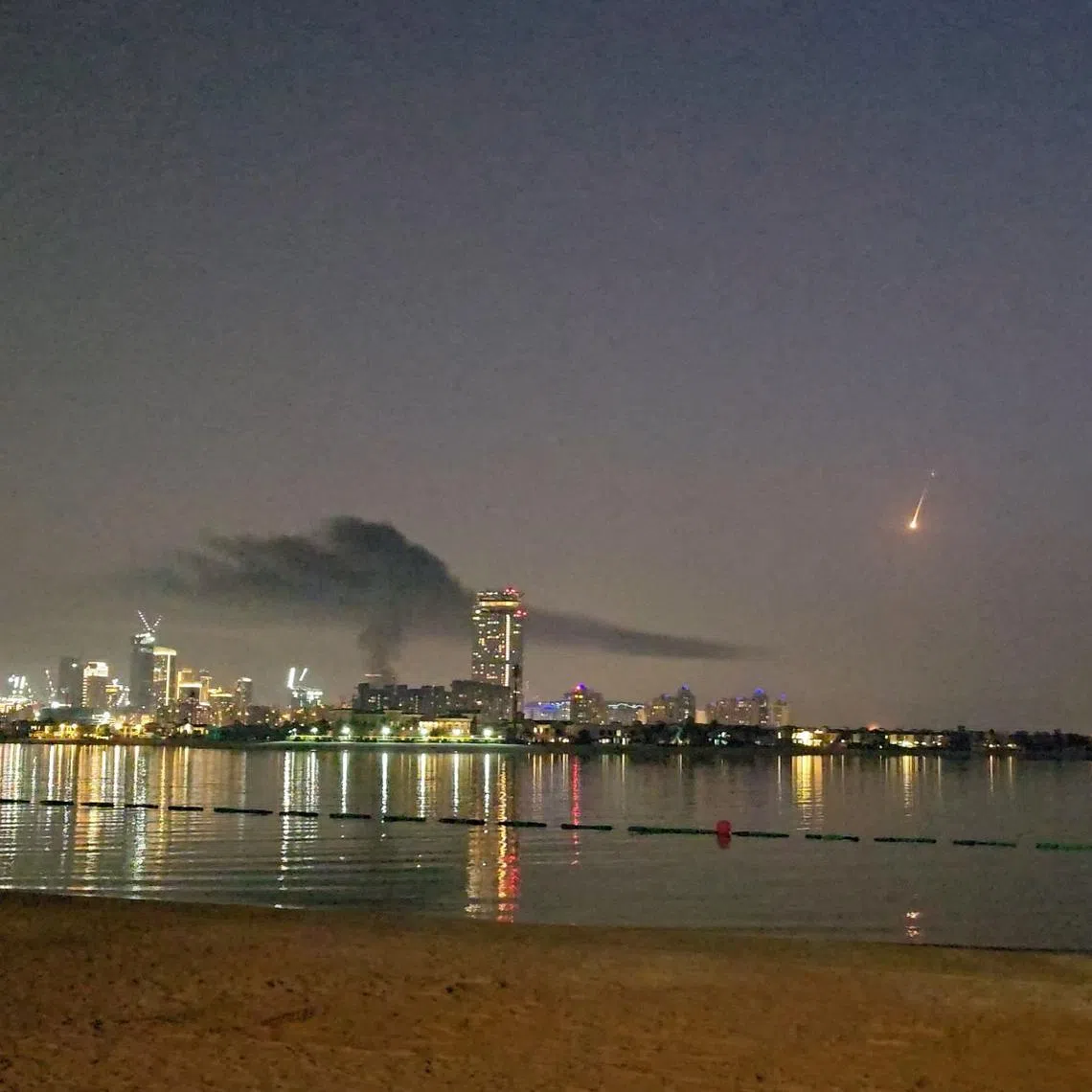 Smoke rising over a damaged hotel in Dubai's famed Palm Jumeirah on Feb 28.