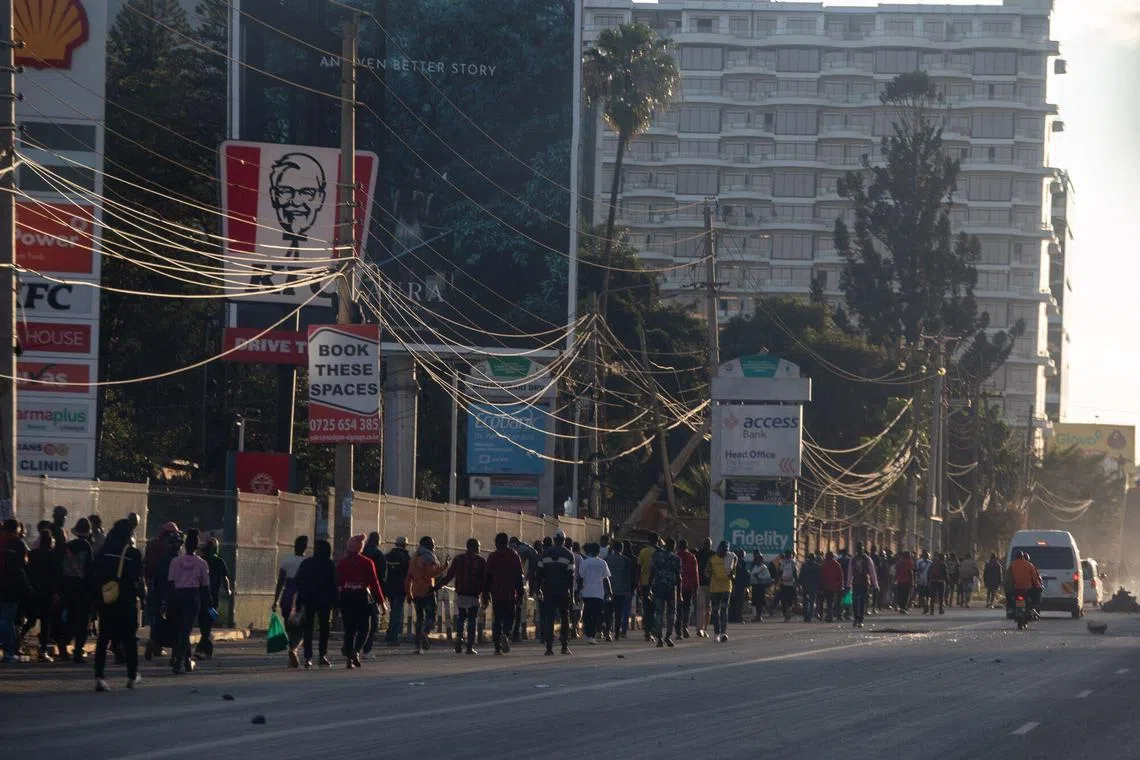 Civilians empty out of the city center after police dispersed protesters against the proposed government tax bill in Nairobi on June 25.