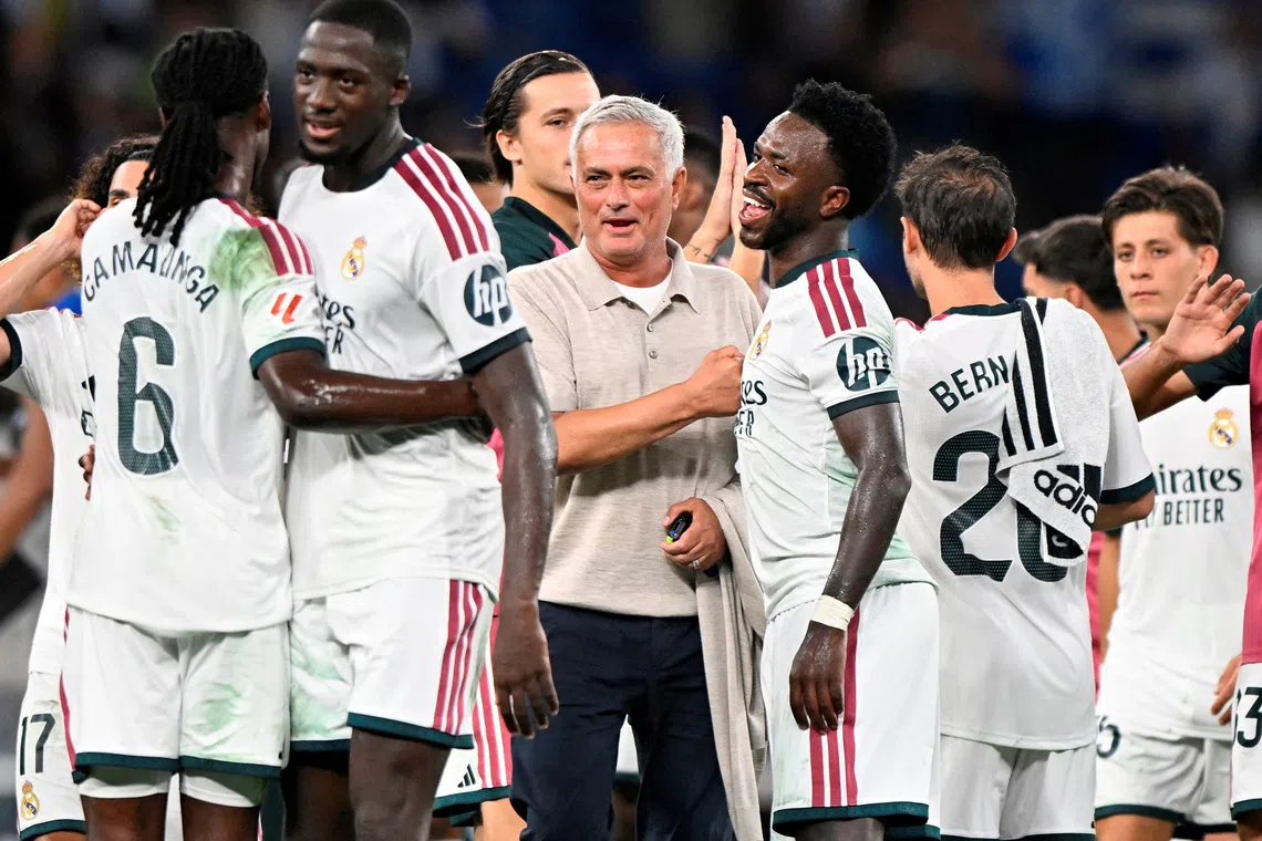 Real Madrid coach Jose Mourinho celebrates after the match with Real Madrid’s Vinicius Junior.