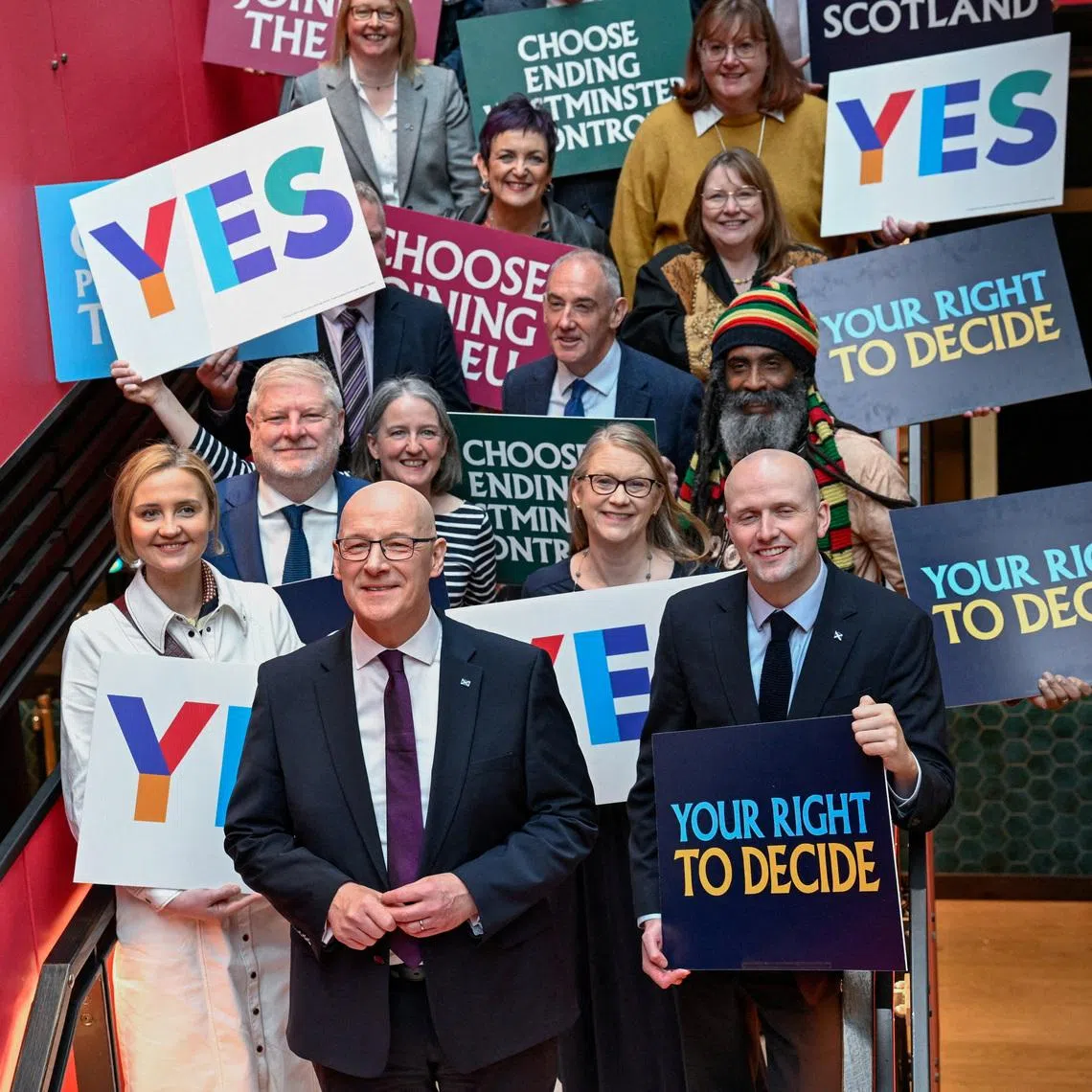 Scottish leader John Swinney (front row, centre) was expected to fall short of winning a majority of the 65 seats in the Scottish Parliament.