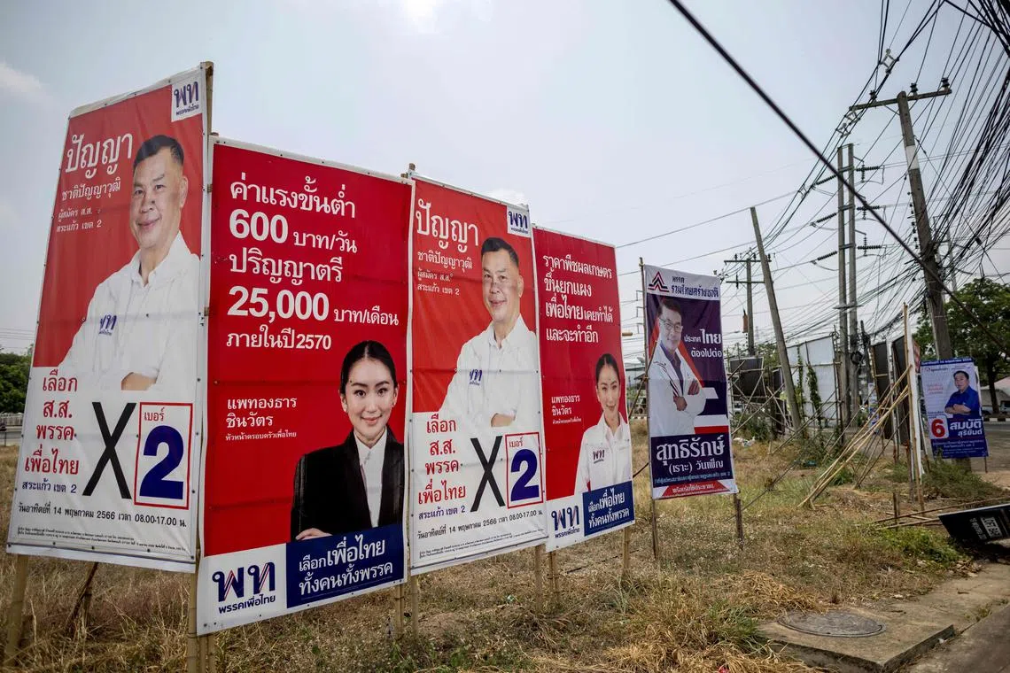 This picture taken on April 22, 2023 shows campaign posters for the upcoming general election in the Thai province of Sa Kaeo. - Politics is a family affair for the Thienthong clan, one of Thailand's most enduring political dynasties, with five members running in next month's general election, for two different parties. (Photo by Jack TAYLOR / AFP) / To go with "Thailand-politics-election-dynasties", FOCUS by Thanaporn PROMYAMYAI and Alexis HONTANG