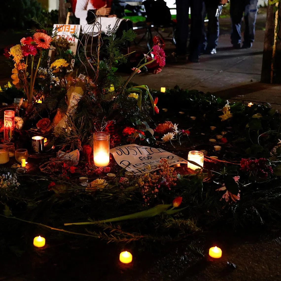 Flowers and candles are placed outside the Portland ICE facility during a vigil, after U.S. federal agents shot two people in Portland, Oregon, U.S., January 9, 2026.  REUTERS/John Rudoff