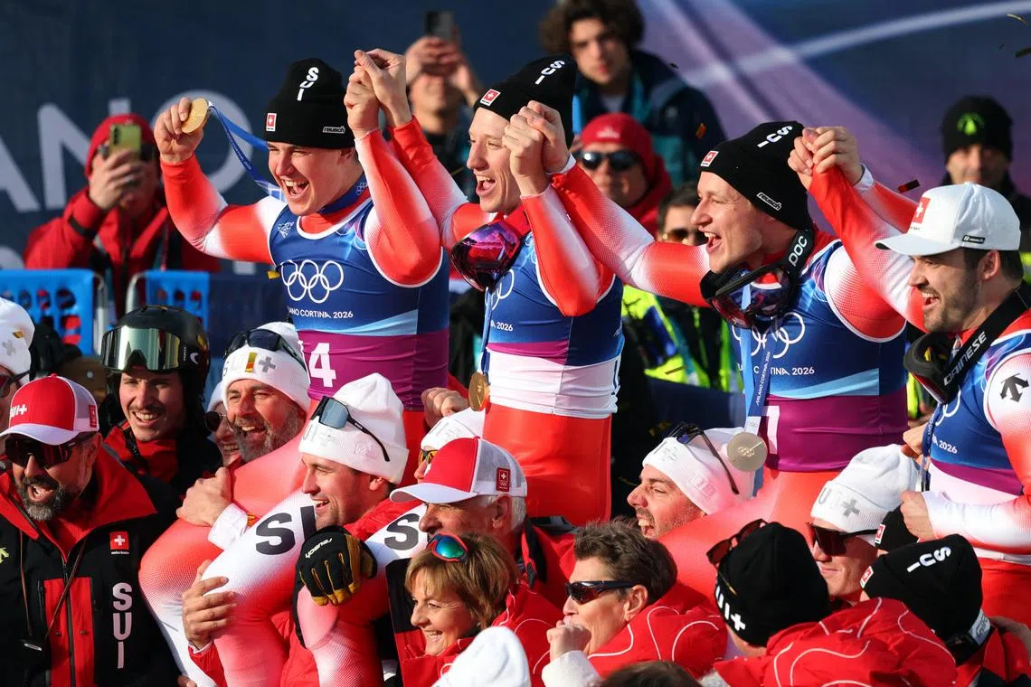 Milano Cortina 2026 Olympics - Alpine Skiing - Men's Team Combined Victory Ceremony - Stelvio Ski Centre, Bormio, Italy - February 09, 2026. Gold medallists Tanguy Nef of Switzerland and Franjo von Allmen of Switzerland and silver medallists Marco Odermatt of Switzerland and Loic Meillard of Switzerland celebrate with their team REUTERS/Denis Balibouse