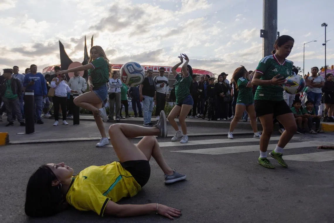 Female fans perform soccer tricks with balls outside Azteca Stadium, officially renamed Estadio Banorte, on the day of a friendly match between the national teams of Mexico and Portugal held to mark the stadium’s inauguration, as Mexico prepares for the 2026 FIFA World Cup co-hosted by the United States, Canada and Mexico, in Mexico City, Mexico, March 28, 2026. REUTERS/Quetzalli Nicte-Ha