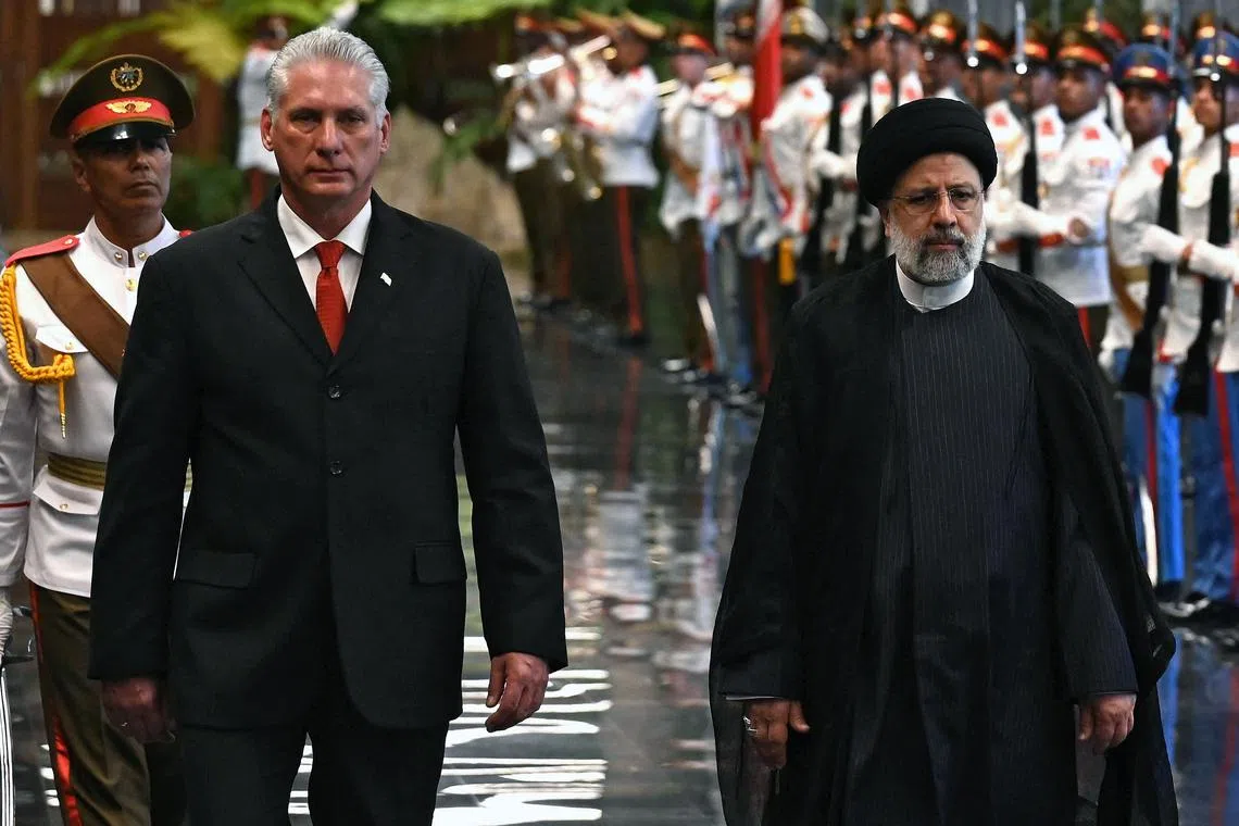 Cuban President Miguel Díaz-Canel (left) and Iranian President Ebrahim Raisi reviewing the honour guard during a welcoming ceremony in Havana on June 15.
