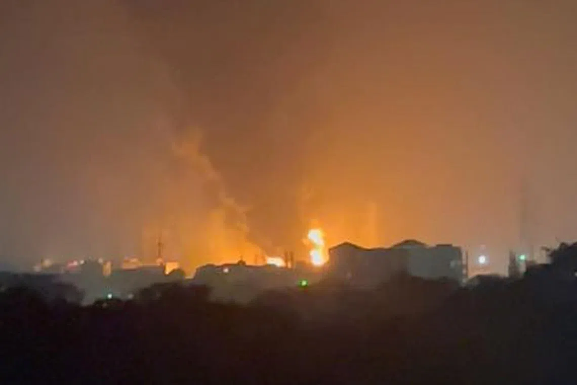 Flames and smoke rise, following a blast at an oil terminal, in Conakry, Guinea December 18, 2023, in this screen grab taken from social media video. Mohamed Fikri Fawaz/via REUTERS