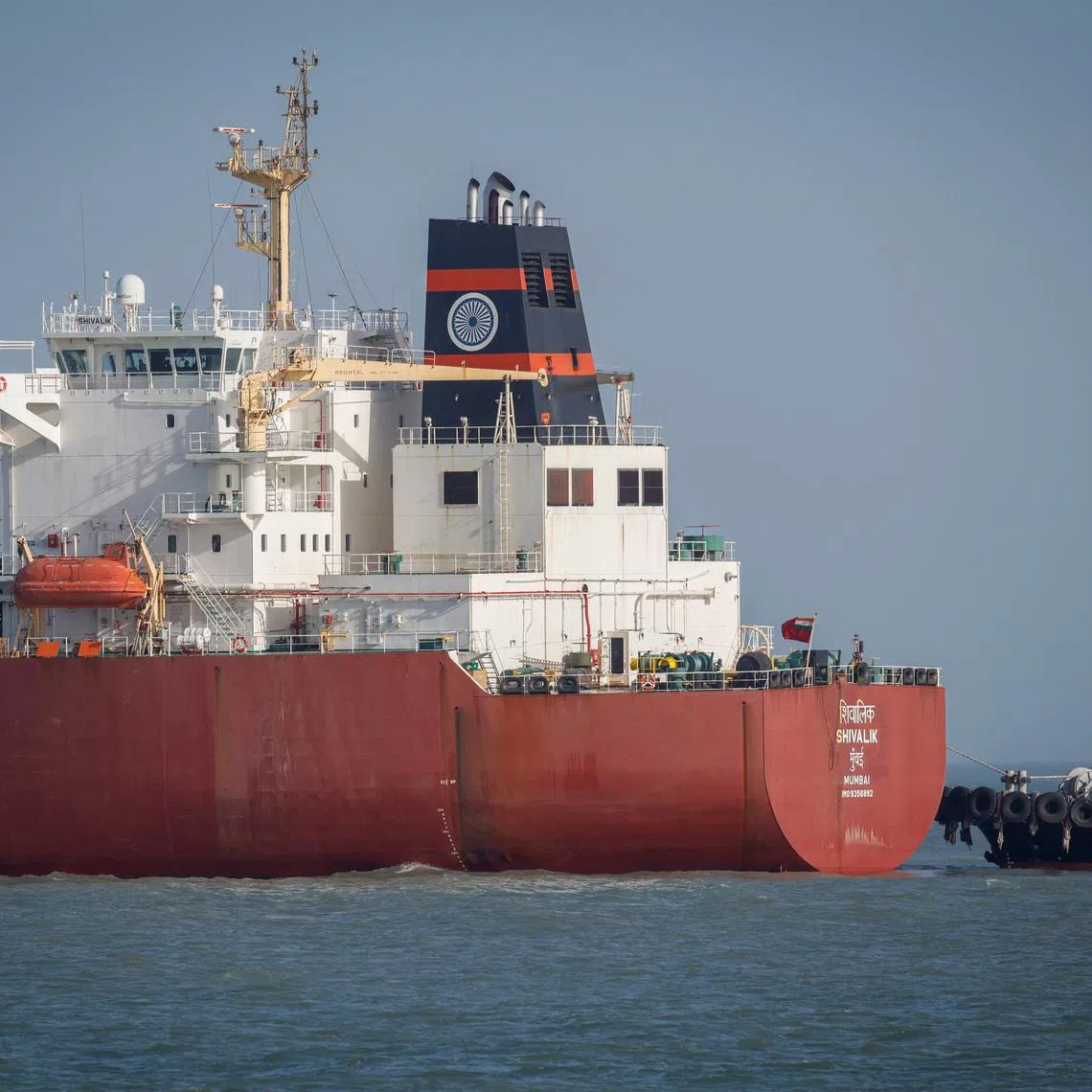 A coastguard boat approaches an Indian liquefied petroleum gas (LPG) carrier, Shivalik, as it arrives at Mundra Port via the Strait of Hormuz, amid the U.S.-Israel conflict with Iran, in Gujarat, India, March 16, 2026. REUTERS/Amit Dave