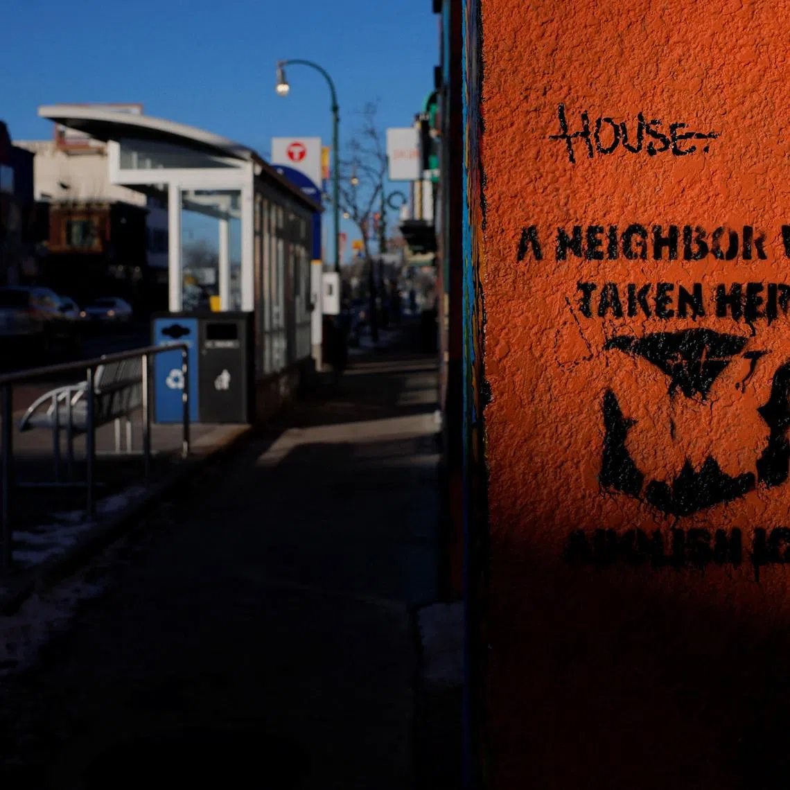 FILE PHOTO: A sign on a wall reads \"A Neighbour Was Taken Here,\" indicating a place where someone was detained by federal immigration agents, in Minneapolis, Minnesota, U.S., January 30, 2026.   REUTERS/Brian Snyder/ File Photo