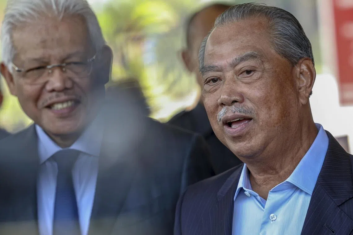 Bersatu president Muhyiddin Yassin and his former deputy Hamzah Zainuddin (left), who was sacked from the party.