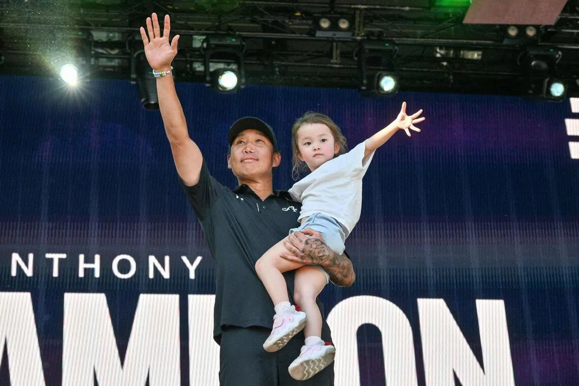 Anthony Kim, 40, celebrates on the podium with his daughter Isabella after he won a golf title for the first time in 5,795 days. 