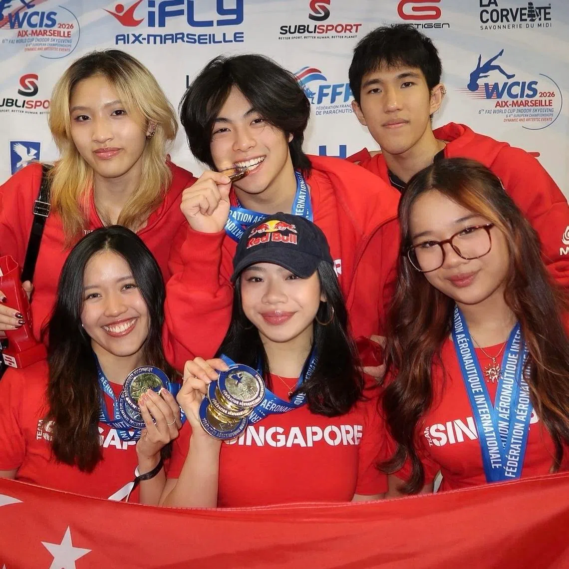 (From left, clock-wise) Singapore's Isabelle Koh, Kai Minejima-Lee, Jordan Lee, Vera Poh, Kyra Poh and Choo Yi Xuan posing with their medals won at the FAI World Cup of Indoor Skydiving.