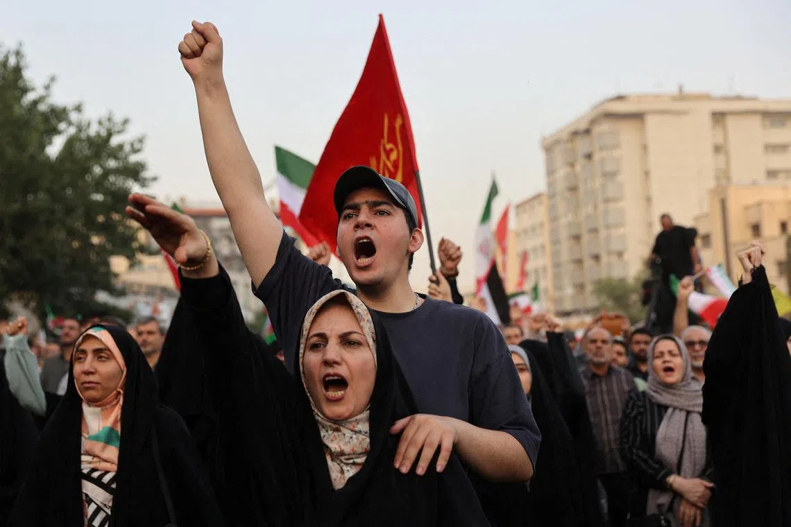People gesture as they attend a gathering to support Iran's Armed Forces, after U.S. President Donald Trump announced a ceasefire between Israel and Iran, in Tehran, Iran, June 24, 2025. Majid Asgaripour/WANA (West Asia News Agency) via REUTERS