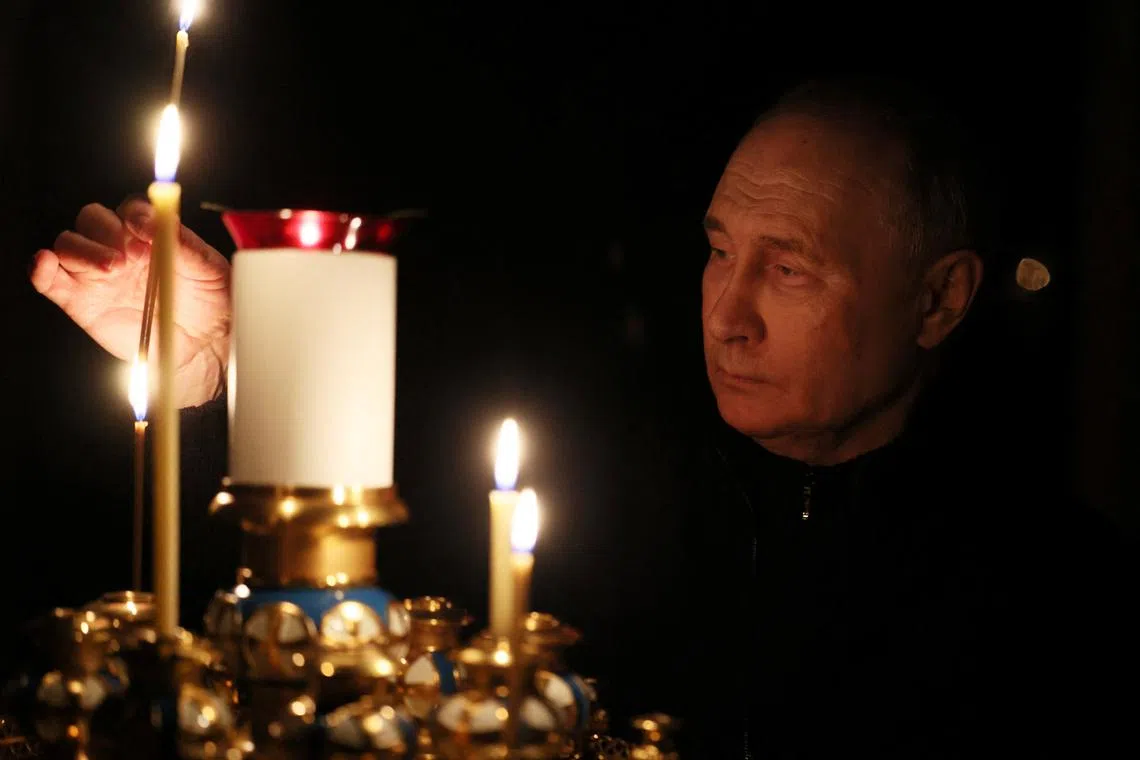 Russian President Vladimir Putin lights a candle in memory of the victims of the Crocus City Hall attack, on the day of national mourning in a church at the Novo-Ogaryovo state residence outside Moscow, Russia March 24, 2024. Sputnik/Mikhail Metzel/Pool via REUTERS