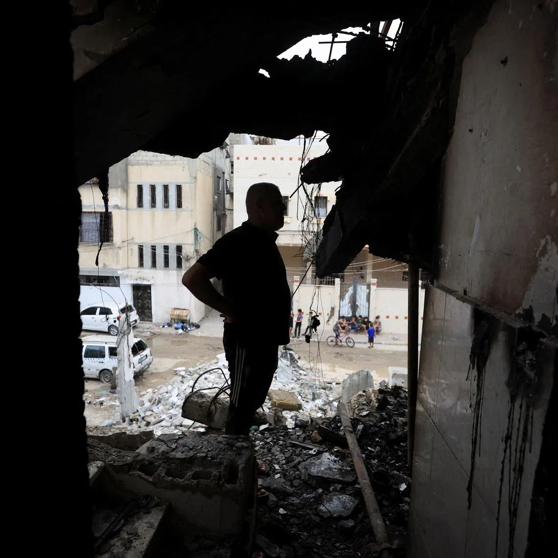 A Palestinian man inspects the site of an Israeli strike on a house in Gaza City, July 21, 2026. REUTERS/Dawoud Abu Alkas