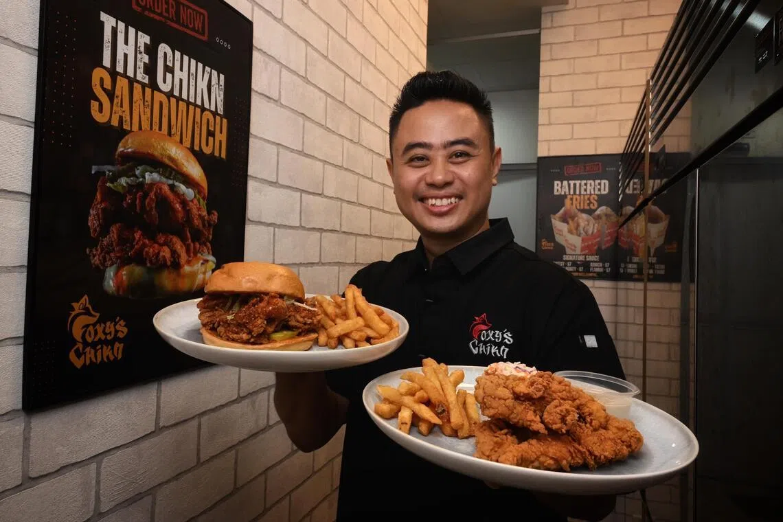 Foxy’s Chikn founder Shahrizan Mohamed Sapri with the Chikn Sandwich Set (left) and the Tenders Set (right).