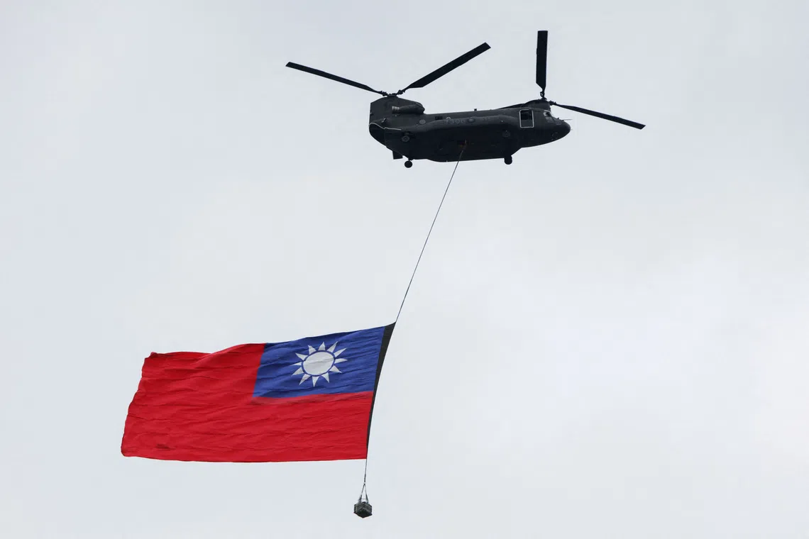 A US-made Chinook helicopter flies with a giant Taiwanese flag during a rehearsal ahead of Taiwan’s National Day celebrations in Taipei on Oct 6.