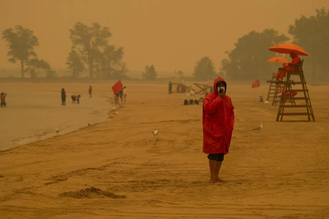 Lifeguards watch over a nearly empty Orchard Beach in the Bronx amid haze from wildfire smoke on June 7, 2023. 