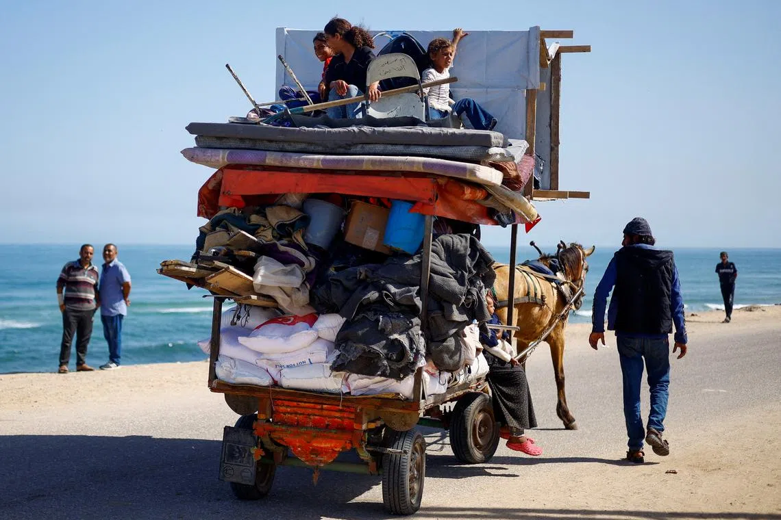 FILE PHOTO: Palestinians travel in an animal-drawn cart as they flee Rafah after Israeli forces launched a ground and air operation in the eastern part of the southern Gaza city, amid the ongoing conflict between Israel and Hamas, in the southern Gaza Strip May 9, 2024. REUTERS/Mohammed Salem/File Photo