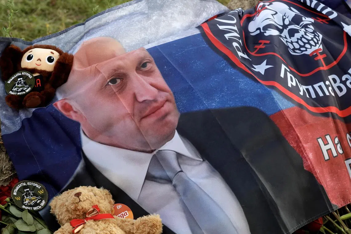 A flag bearing the image of Yevgeny Prigozhin and the emblem of the Wagner Group is seen at a makeshift memorial near the group's headquarters in St Petersburg.