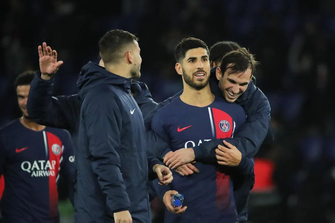 Paris Saint-Germain attacker Marco Asensio mobbed by his teammates after their side's clash with Lille on Feb 10.