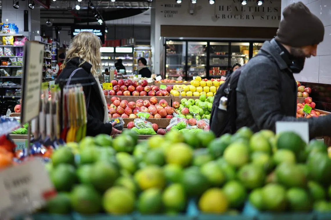 People shop in a supermarket in the Manhattan borough of New York City on February 20, 2025. (Photo by CHARLY TRIBALLEAU / AFP)