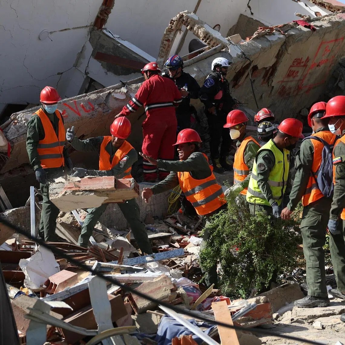 Members of the military remove debris at the site of a collapsed building in the aftermath of the June 24 earthquakes in La Guaira, Venezuela.