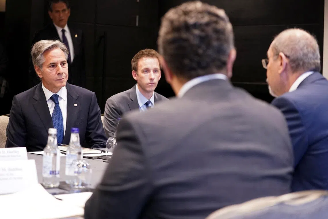 U.S. Secretary of State Antony Blinken, flanked by Counselor of the U.S. Department of State Tom Sullivan, meets with Jordanian Foreign Minister Ayman Safadi in London, Britain, October 25, 2024. REUTERS/Nathan Howard/Pool