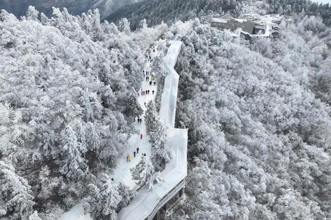 People visit the Nanyue Hengshan scenic area after a snowfall in Hengyang, in China’s central Hunan province.