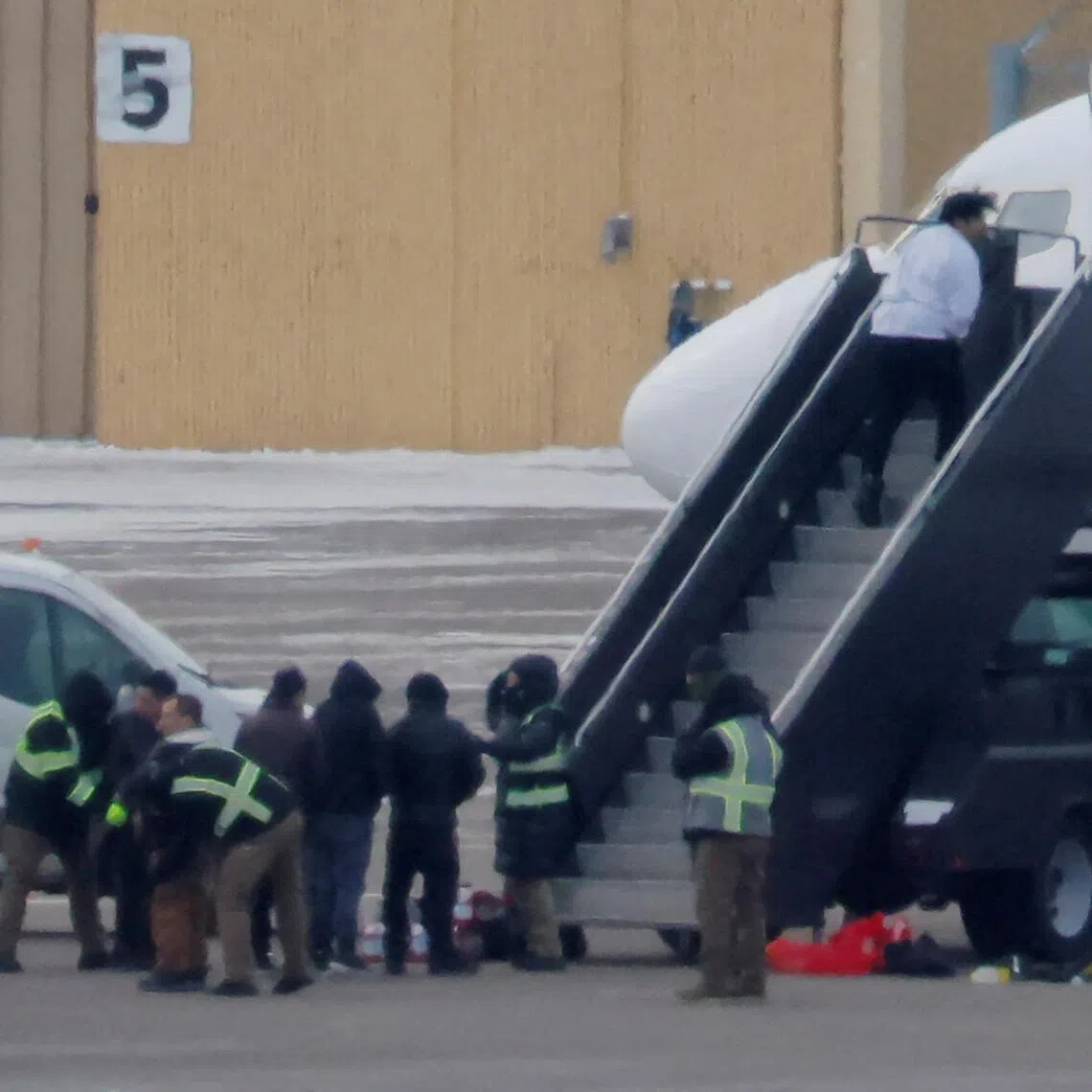 Detainees boarding a deportation flight in Minneapolis, Minnesota, on Jan 17.