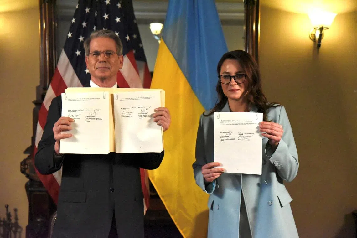 FILE PHOTO: U.S. Treasury Secretary Scott Bessent and Ukrainian First Deputy Prime Minister Yulia Svyrydenko pose after signing a deal that will give the United States preferential access to new Ukrainian minerals deals and fund investment in Ukraine's reconstruction, in Washington, D.C., U.S., April 30, 2025, in this picture obtained from social media.  Yulia Svyrydenko via Facebook/via REUTERS/File photo