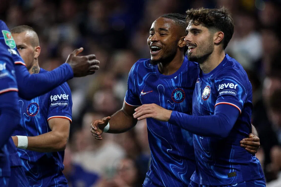 Chelsea's French striker Christopher Nkunku (second from right) celebrates scoring the team's second goal against Barrow at Stamford Bridge.