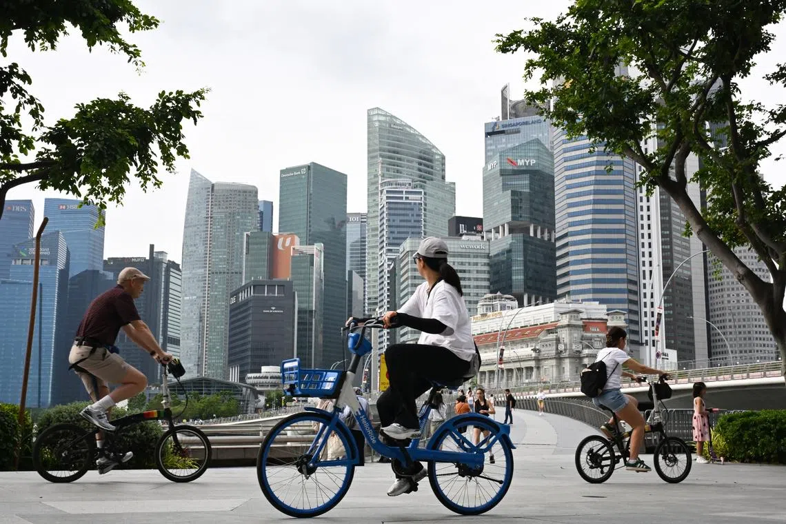 Cyclists and people near the Jubilee Bridge with the Central Business District (CBD) skyline on Dec 31, 2025.  The top lesson from immigration convulsions elsewhere is to do everything possible to avoid the toxicity of conversations rooted in zero-sum politics.