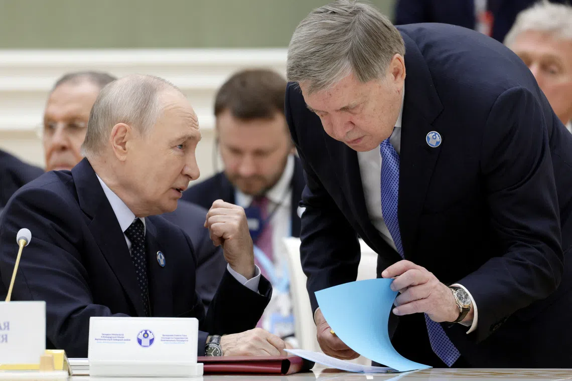 Russian President Vladimir Putin speaks with Kremlin foreign policy adviser Yuri Ushakov during a summit of the CIS Council of Heads of State in Turkmenbashi, Turkmenistan, October 9, 2026. Sputnik/Gavriil Grigorov/Pool via REUTERS