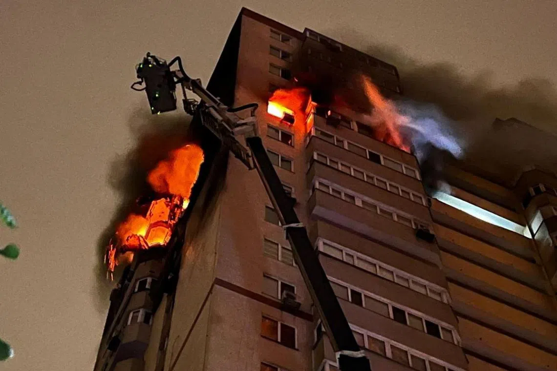 Flames and smoke rising from an apartment building damaged during a Russian drone strike, in Kyiv, Ukraine, on Oct 25.
