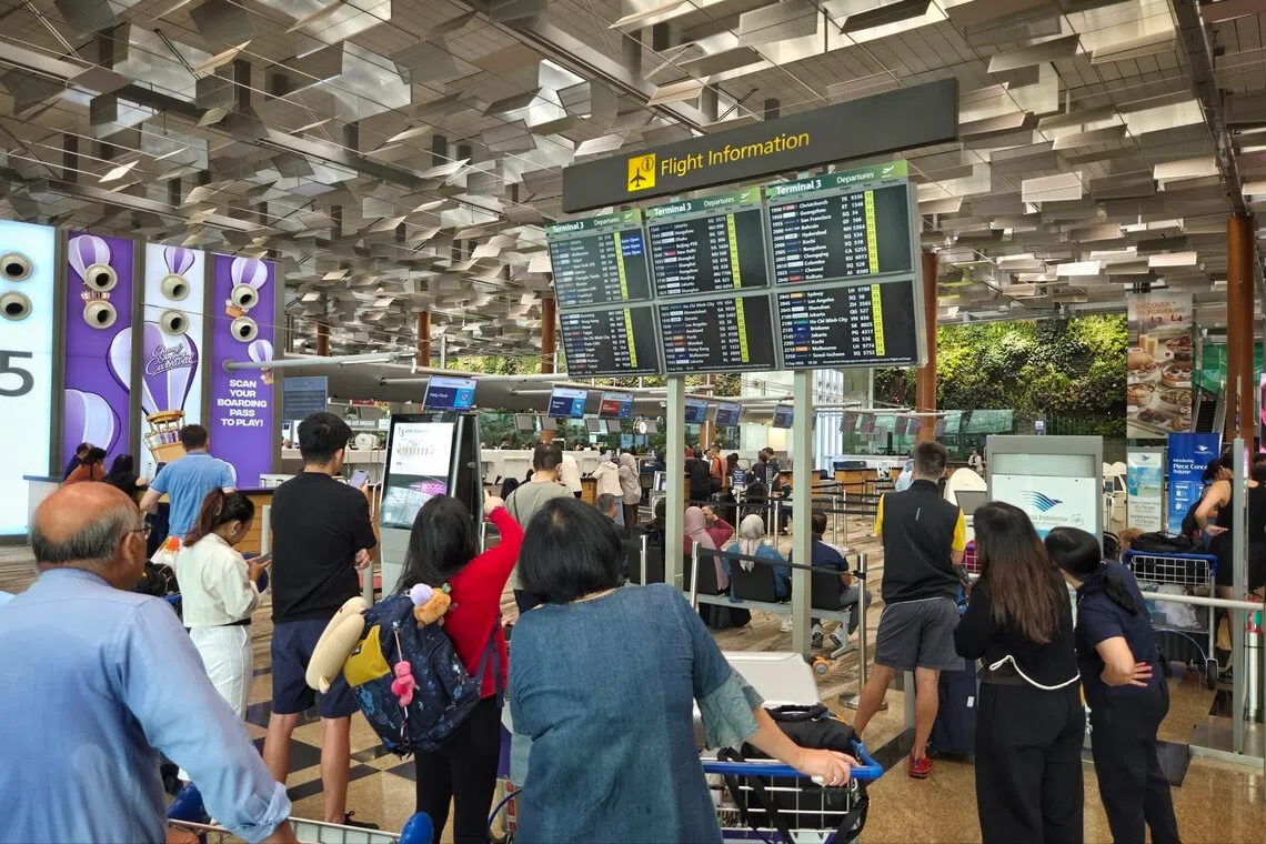 Affected commuters near Garuda Airlines check-in counter at Changi Airport Terminal 3  on Sept 6.