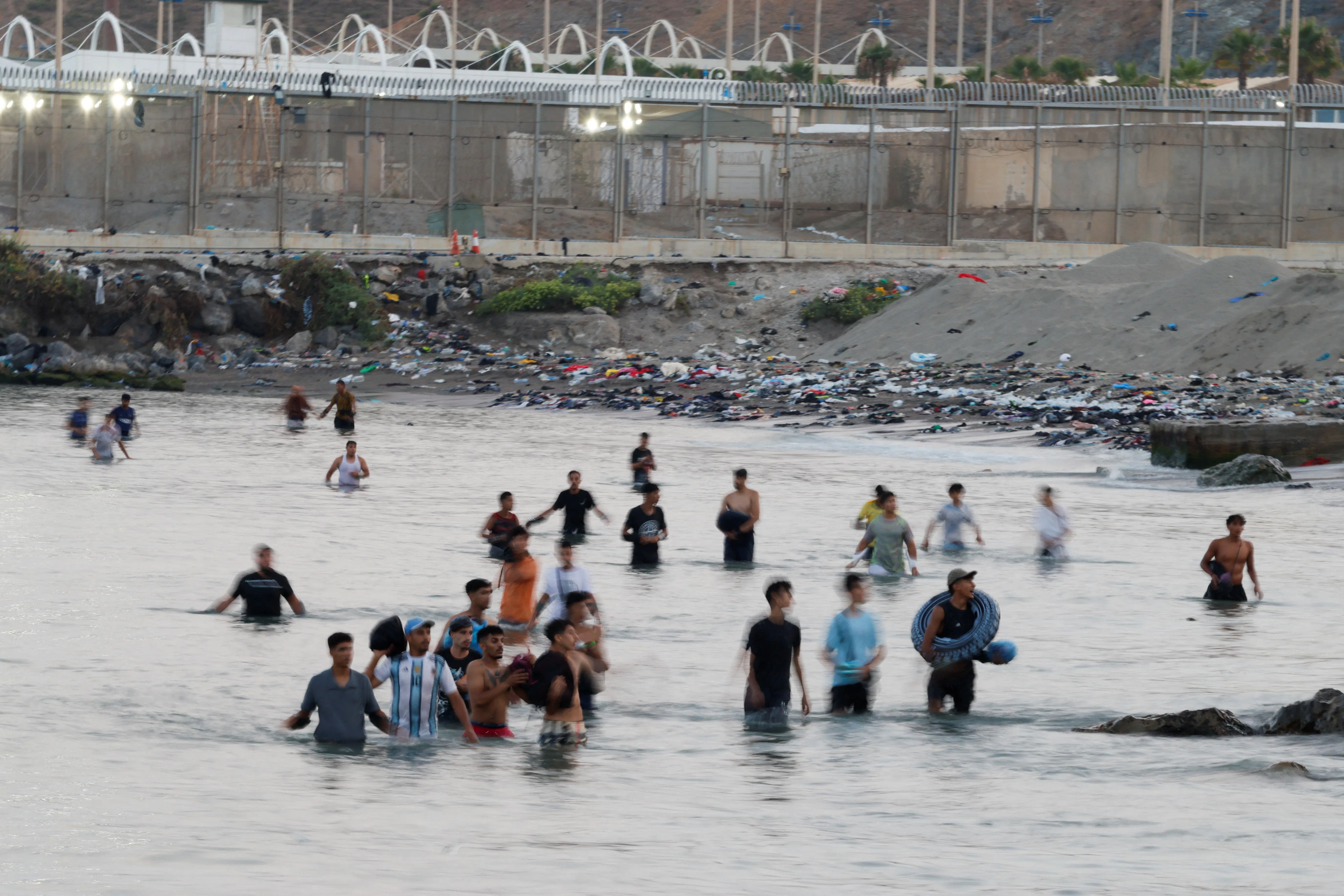 Migrants cross into Ceuta by sea, at El Tarajal beach, amid mass crossings of migrants from Morocco into Spanish territory, in Ceuta, Spain, July 31, 2026. REUTERS/Jon Nazca