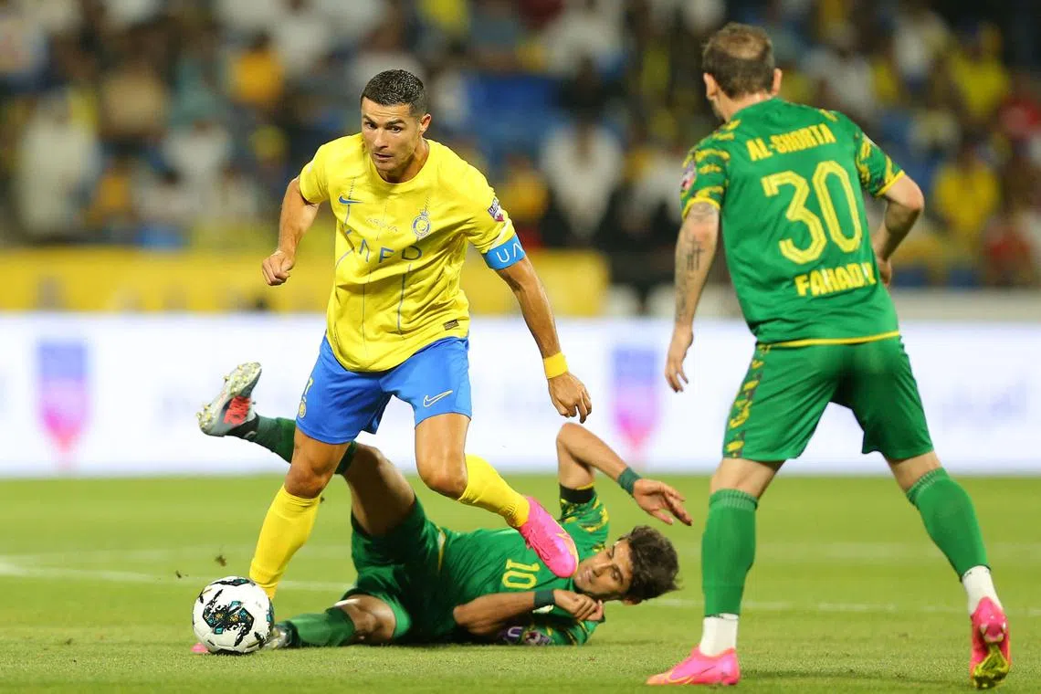 Al-Nassr striker Cristiano Ronaldo vies for the ball with Al-Shorta forward Alaa Al-Azzawi during the Arab Club Champions Cup semi-final at Prince Sultan bin Abdul Aziz Stadium.