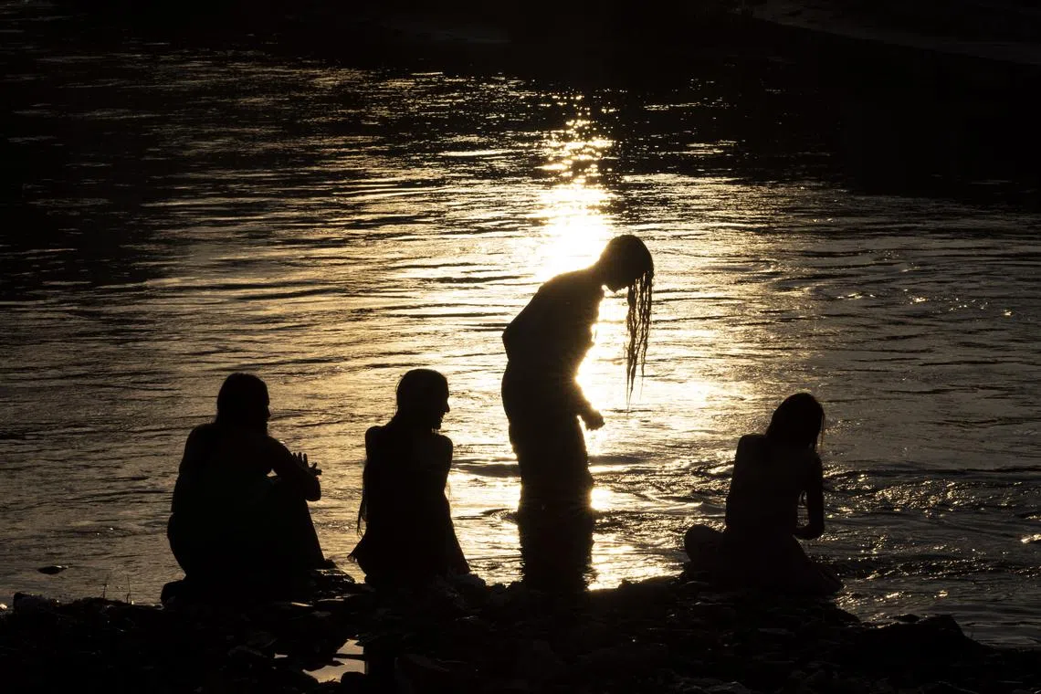 A group of women taking a ritual holy bath to purify themselves to mark the Rishi Panchami festival, in the Bagmati River in Kathmandu, Nepal on Sept 19.